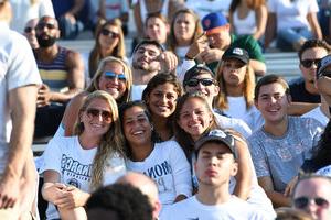 Students pose at a football game.